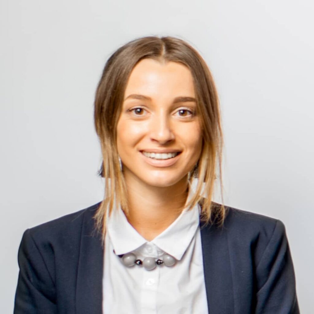 A lady in blue blazer smiling